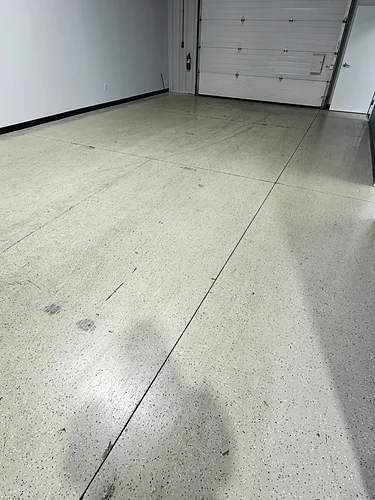 Polished warehouse concrete reflecting the overhead lighting