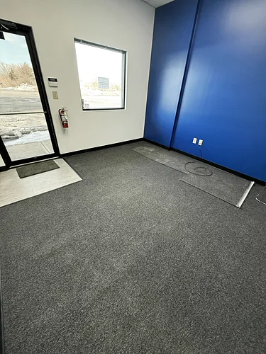 A cleaned office with a blue accent wall and freshly vacuumed carpet