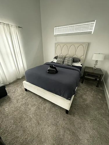 A short-term rental bedroom after turnover: the bed made up with fresh linens