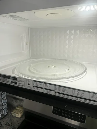 The inside of a microwave wiped clean during a rental turnover