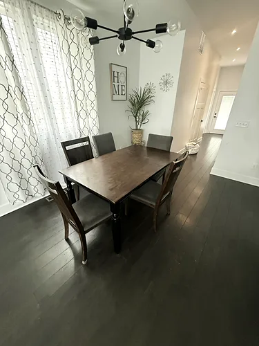 A wiped-down dining table set and ready for the next guests