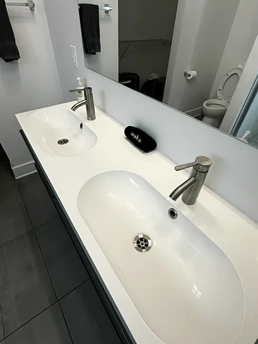 A double vanity wiped clean in a rental bathroom after turnover